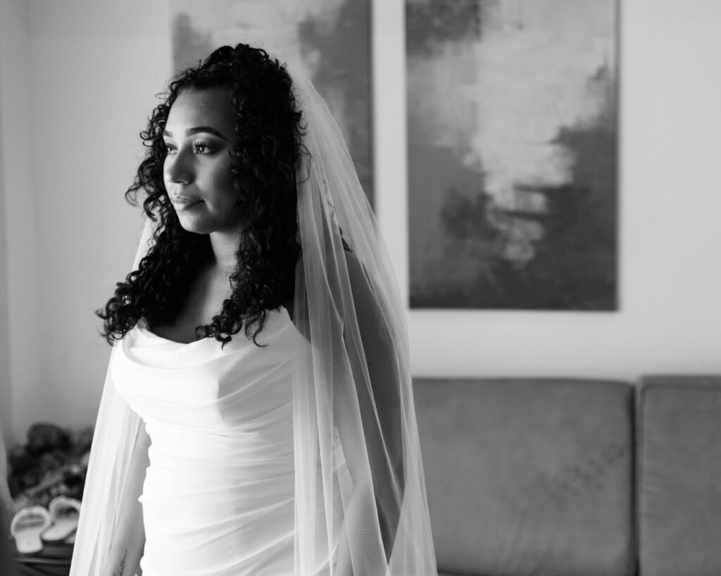 Black-and-white portrait of the bride in her veil — photographed by 121 Media Group