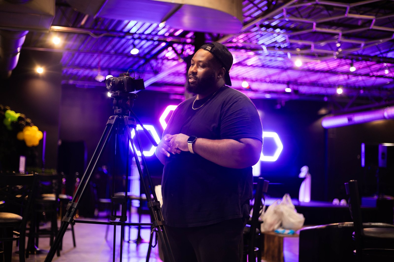 Video production set with a cinema camera and neon lighting