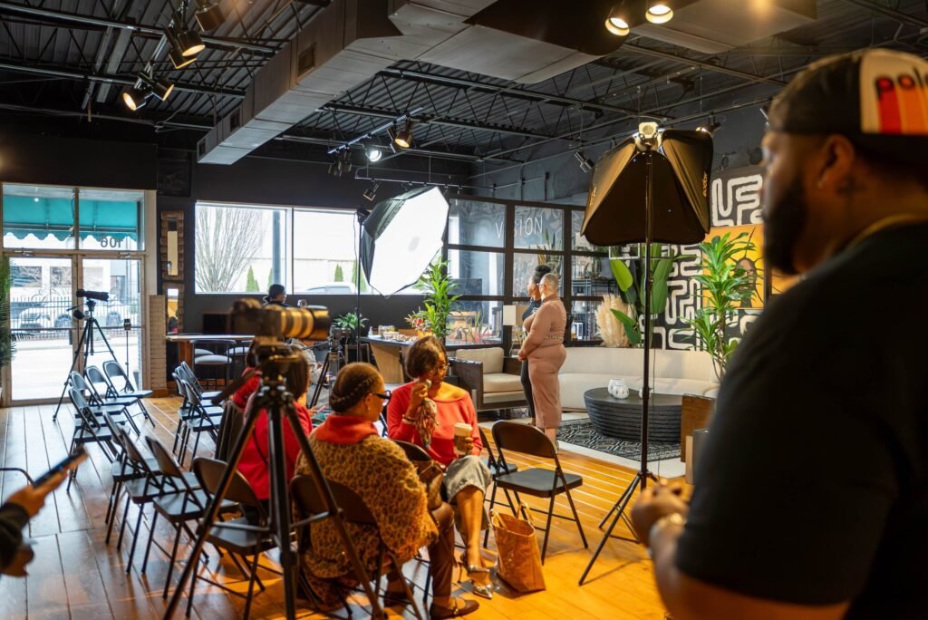 Production crew and lighting setup at a live podcast event — photographed by 121 Media Group