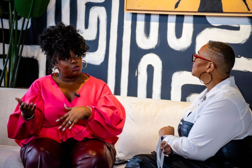 Podcast guest gesturing while talking with the host — photographed by 121 Media Group